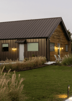 Surround yourself with the natural beauty and serene landscaping of Element Ranch Retreats, where tranquility and luxury unite. The exterior of a retreat at Element Ranch, surrounded by lush landscaping, serene outdoor spaces, and natural beauty.